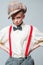 Hip and stylish. teen girl in retro male suit. vintage english style. jazz step fashion. suspender and bow tie. old