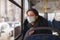 Hipanic woman with medicine mask in empty bus