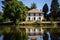 a hipped roof french chateau near a calm lake