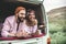 Hippie beloved couple resting in trunk of van