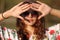 Hippie girl in sunglasses covers her face from the sun hand Outdoors