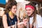 Hippie man wearing bright red headband looking at his girlfriend hand