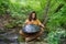 Hippie playing handpan music on the shore of a river