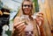 Hippie style woman examines joints and buds of medical marijuana.