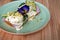 Hipster avocado toast with poached egg and hollandaise sauce, decorated with flower