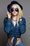 Hipster blond girl in hat and sunglasses