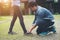 Hipster boyfriend tying shoes to his girls while go the relaxing