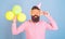 Hipster with bushy beard celebrating birthday. Bearded man posing in birthday cap with enormous glasses and bright