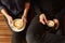 Hipster couple with cappucino and espresso from overhead