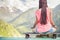 Hipster fashion girl doing yoga, relaxing on skateboard at mountain