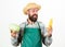 Hipster gardener in apron hold vegetable. Farmer straw hat hold corncob cabbage vegetable. Man bearded presenting