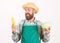 Hipster gardener in apron hold vegetable. Farmer straw hat hold corncob cabbage vegetable. Man bearded presenting