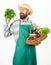 Hipster gardener wear apron carry vegetables. Farmer straw hat hold parsley and basket vegetables. Man bearded