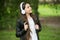 Hipster girl listening music modern headphones nature background, mood and emotions concept