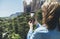 Hipster girl making photo on smartphone mobile closeup, view tourist hands using gadget phone in travel on background mountains