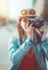 Hipster girl making picture with retro camera, focus on camera