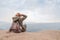 Hipster girl sitting in rocky of mountain