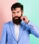 Hipster handsome attractive guy with long beard. Man bearded hipster twisting mustache pink blue background. Ultimate