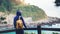 Hipster hiker tourist with backpack looking on seascape sunset, background blue sea and mountain, guy enjoying ocean horizon