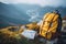 Hipster Hiker Tourist with Yellow Backpack and Map Exploring Europe in the Serene Mountain Landscape - Traveler\\\'s
