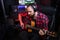 Hipster man with beard in headphone is playing guitar and sining his new song in stereo studio to record brand-new track
