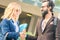 Hipster man and blond woman handshaking at informal business date