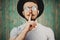 Hipster man gesture for silence showing hush sign