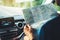 Hipster man looking and point finger on location navigation map in car, tourist traveler driving and hold in male hands europe car