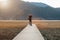 Hipster man traveler with sweater and backpack traveling at Napa Lake, Photographer taking photo to mountain view in trip Shangri-