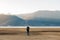 Hipster man traveler with sweater and backpack traveling at Napa Lake, Photographer taking photo to mountain view in trip Shangri-