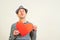 Hipster with paper red heart. Air kiss and love. Funny happy man holds symbols of Valentine`s day. Kiss, flirt, gift, feeling