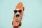 Hipster penny board, one sneaker and sunglasses making smiley composition