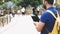 Hipster person holding in hands digital tablet with blank screen, man photograph on computer on background nature park palm