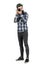 Hipster in plaid shirt taking photo with dslr camera looking at camera.