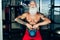 Hipster senior man training inside gym - Mature tattooed person having fun doing workout exercises in sport fitness club - Active