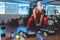 Hipster senior man training inside gym - Mature tattooed person having fun doing workout exercises in sport fitness club - Active
