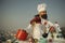 Hipster smiling with ladle in white uniform