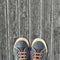 Hipster sneakers on a light wooden background