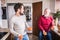 Hipster son with his senior father in the kitchen.