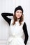 Hipster Style Brunette Girl Swag wearing Black fashion beanie knitted hat with bumbon pumpon. Season Fall Winter