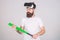 Hipster with stylish beard testing virtual reality gaming equipment. Bearded man in VR headset holding baseball bat
