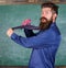 Hipster teacher formal wear necktie holds stapler. School stationery. Man scruffy use stapler dangerous way. Teacher