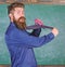 Hipster teacher formal wear necktie holds stapler. School stationery. Man scruffy use stapler dangerous way. Teacher