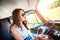 Hipster teenage girl inside an old campervan driving, roadtrip