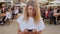 Hipster teenager at festival uses smartphone