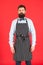 Hipster waiter. Hipster cafe concept. Man with beard cook hipster apron. Hipster chef cook red background. Bearded man