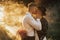 Hipster wedding couple kissing in forest in sunset light in fog