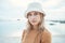 Hipster woman, holiday at the beach and portrait of calm or relaxing Norway coastal getaway trip. Peaceful summer
