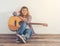 Hipster woman style portrait chilling with guitar look so happy.