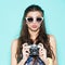 Hipster woman taking photos with retro film camera